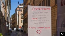 A hand written notice on the window of a shop advises that the shop will remain close for public health reason, concluding "All will be fine", in downtown Rome, March 12, 2020. 