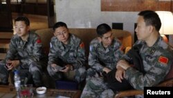 U.N. observers from China at at hotel in Damascus before heading to areas where protests against Syrian President Bashar al-Assad have been taking place, May 18, 2012.