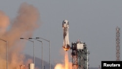 FILE - A Blue Origin New Shepard rocket lifts off from Launch Site One in west Texas, Dec. 11, 2021. 