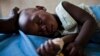 FILE - A young girl with malaria rests in the inpatient ward of the Malualkon Primary Health Care Center in Malualkon, in the South Sudanese state of Northern Bahr el Ghazal, June 1, 2012.