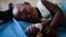 A young girl with malaria rests at a health clinic in the South Sudanese state of Northern Bahr el Ghazal, June 1, 2012.