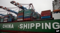 FILE - Containers are pictured on board of the 'Star' vessel of the China Shipping Container Lines shipping company at the harbour in Hamburg, Germany.