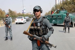 Afghan policemen stand guard at a checkpoint, Sept. 26, 2019, ahead of presidential elections scheduled for Sept. 28, in Kabul, Afghanistan.