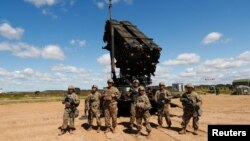 U.S. soldiers stand next to a Patriot missle system during Toburq Legacy 2017, an air defense exercise, in a military airfield near Siauliai, Lithuania, July 20, 2017.