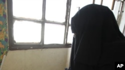 A veiled woman casts her vote during the second day of the parliamentary run-off elections at a polling station in Cairo, December 6, 2011.