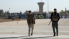 Members of the Kurdish-led Syrian Democratic Forces walk at Qamishli international airport in Qamishli, Syria, Dec. 9, 2024. 