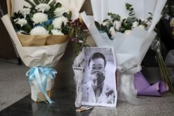A makeshift memorial for Li Wenliang, a doctor who issued an early warning about the coronavirus outbreak before it was officially recognized, is seen after Li died of the virus, at Central Hospital of Wuhan in Hubei province, China Feb. 7, 2020.