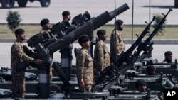 FILE - Army troops take part in the Pakistan National Day parade in Islamabad, Pakistan.