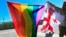 FILE - Georgian LGBT activists attend a rally against homophobia outside the State Chancellery to mark international day against homophobia, in downtown Tbilisi, Georgia, Wednesday, May 17, 2017.