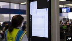 A technician works on an information display near United Airlines gates at Chicago O'Hare International Airport in Chicago, July 19, 2024, after a faulty CrowdStrike update caused a major internet outage for computers running Microsoft Windows. 