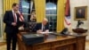President Donald Trump signs an executive order withdrawing the U.S. from the World Health Organization in the Oval Office of the White House, Jan. 20, 2025, in Washington.