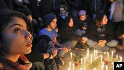 Young people gather around candles as they begin three days of mourning Friday to mourn dozens who died in the protests that drove their autocratic leader from power, in Tunis, January 22, 2011 (File Photo)