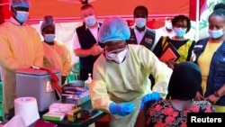 A Ugandan doctor vaccinates the contact of a patient who tested positive during the launch of the vaccination for the Sudan strain of the Ebola virus with a trial vaccine at the Mulago Guest House isolation center in Kampala, Feb. 3, 2025. 