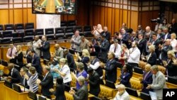 South African DA, Democratic Alliance party leader, Mmusi Maimane, far left, is applauded by his party members after he called for a motion to remove South African President Jacob Zuma as President at Parliament in Cape Town, South Africa, Nov. 10, 2016.
