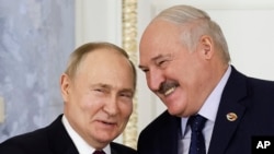 FILE - Russian President Vladimir Putin and Belarusian President Alexander Lukashenko shake hands during a meeting in St. Petersburg, Russia, on Jan. 29, 2024. Lukashenko has depended on Russian support throughout his 30-year rule.