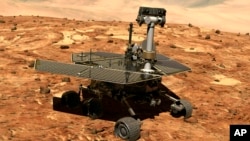 FILE - This illustration made available by NASA shows the rover Opportunity on the surface of Mars. The exploratory vehicle landed on Jan. 24, 2004 and finally fell silent during a dust storm in June 2018.