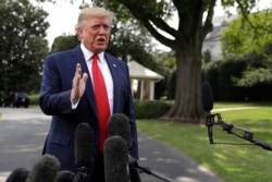 President Donald Trump talks to reporters before departing for a campaign rally, on the South Lawn of the White House, Aug. 1, 2019.