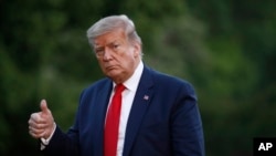 FILE - President Donald Trump gestures as he walks across the South Lawn of the White House in Washington, May 30, 2020.