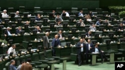 Iranian lawmakers attend a session of parliament in Tehran, April 16, 2019. Iran's lawmakers overwhelmingly approved a bill labeling U.S. forces in the Middle East as terrorist, a day after the U.S. terrorism designation for Iran's Revolutionary Guard formally took effect.