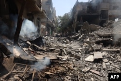 Menghancurkan bangunan menyusul operasi Pasukan Khusus Israel di kamp Nuseirat, di Jalur Gaza tengah pada 8 Juni 2024, di tengah konflik yang sedang berlangsung antara Israel dan kelompok militan Hamas Palestina. (Foto: AFP)