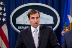 FILE - Assistant Attorney General for National Security John C. Demers speaks during a news conference at the Department of Justice in Washington, Nov. 1, 2018.