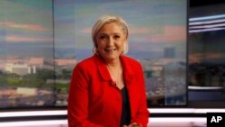 Former French presidential election candidate for the far-right Front National party Marine Le Pen poses prior to an interview, May 18, 2017, in Boulogne-Billancourt, near Paris. 