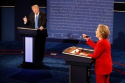 FILE - Republican presidential nominee Donald Trump and Democratic presidential nominee Hillary Clinton speak simultaneously during their first presidential debate at Hofstra University in Hempstead, New York, Sept. 26, 2016.