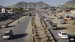 Vehicles cross on newly-constructed Darul Aman street in Kabul, Afghanistan, April 21, 2011.