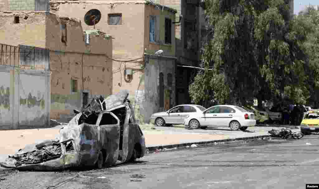 A burnt car in the al-Midan neighborhood in Damascus, July 20, 2012. 
