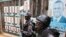 FILE - Policemen stand in front of the gate of opposition leader Kizza Besigye's office in Kampala, Uganda.