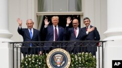 Israeli Prime Minister Benjamin Netanyahu, left, President Donald Trump, Bahrain Foreign Minister Khalid bin Ahmed Al Khalifa and United Arab Emirates Foreign Minister Abdullah bin Zayed al-Nahyan gather at the White House, Sept. 15, 2020.