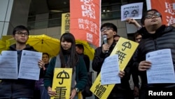 FILE -Hong Kong student leaders (L-R) Oscar Lai, Agnes Chow, Joshua Wong and Derek Lam speak as they arrive at the police headquarters in Hong Kong January 16, 2015.