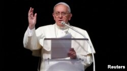 Pope Francis delivers a speech during the Angelus prayer from the window of the Apostolic palace in Saint Peter's Square at the Vatican, Jan. 12, 2014.