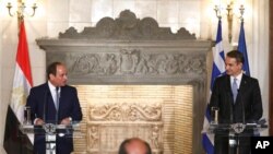 Greek Prime Minister Kyriakos Mitsotakis, right, and Egyptian President Abdel-Fattah el-Sissi attend a joint news conference at Maximos Mansion in Athens, Nov. 11, 2020.