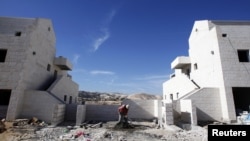 A Palestinian labourer works at a construction site in the West Bank Jewish settlement of Maale Adumim, near Jerusalem December 2, 2012.