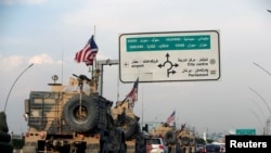 FILE - A convoy of U.S. vehicles is seen after withdrawing from northern Syria, in Erbil, Iraq, Oct. 21, 2019.