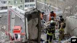 Rescuers search for civilians who were killed when a Russian drone hit an apartment building in Sumy, Ukraine, Jan. 30, 2025. (Ukrainian Emergency Service via AP)