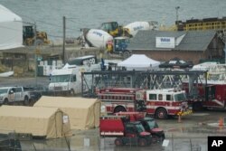 Emergency vehicles and recovery operations are seen near the mouth of the Anacostia River at the Potomac River near Ronald Reagan Washington National Airport, Jan. 31, 2025.