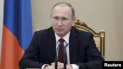 FILE - Russian President Vladimir Putin chairs a meeting with members of the Security Council at the Kremlin in Moscow, Russia, Jan. 22, 2016. Seventy-four percent of Russians would vote to re-elect Putin as president, according to a poll by VTsIOM.