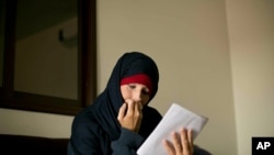 In this Wednesday, April 3, 2019, photo, Kimberly Gwen Polman, a Canadian national, reads a letter at camp Roj in Syria.