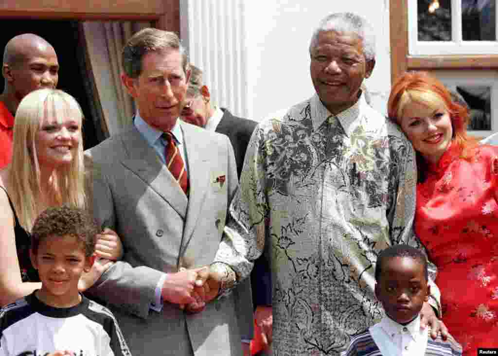 President Nelson Mandela and Britain&#39;s Prince Charles shake hands alongside members of the Spice Girls, Nov. 1, 1997.