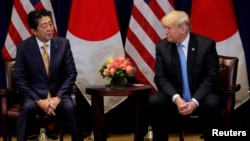 FILE - U.S. President Donald Trump listens to Japan's Prime Minister Shinzo Abe during a meeting on the sidelines of the 73rd session of the U.N. General Assembly in New York, Sept. 26, 2018.