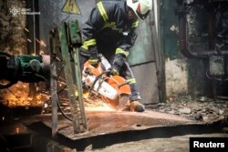 A Ukrainian rescuer works at the site of a Russian military strike in the Kyiv region on April 11, 2024. (Press service of the State Emergency Service of Ukraine via Reuters)