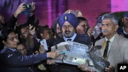 Defense officials display a part of an air-to-air AMRAAM missile which was allegedly fired by Pakistani Air Force aircraft violating Indian airspace, in New Delhi, India, Thursday, Feb. 28, 2019. 