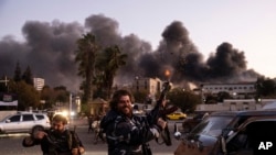 People shoot in the air as they celebrate the fall of the Syrian government in Damascus, Syria, Sunday, Dec. 8, 2024.