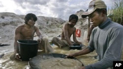 Traditional miners pan for gold at a mine in Hampalit, Central Kalimantan, Indonesia.