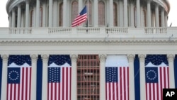 Flags hang in place on the West Front of the U.S. Capitol ahead of President-elect Donald Trump's inauguration, in Washington, Jan. 12, 2025.