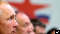 Russian President Vladimir Putin attends a meeting during his visit to Far East Zvezda Plant in Bolshoy Kamen, about 20 kilometers (12 miles) from Vladivostok, Russia, Tuesday, Sept. 11, 2018.