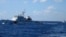 FILE - Chinese ships chase Vietnamese vessels, not shown, after they came within 10 nautical miles of a Chinese oil rig in the South China Sea, July 15, 2014. 