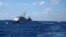 FILE - Chinese ships chase Vietnamese vessels, not shown, after they came within 10 nautical miles of a Chinese oil rig in the South China Sea, July 15, 2014. 